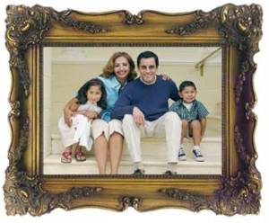 A framed image of a family sitting on the steps of their home.