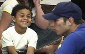 An image of a smiling boy talking with a SKITuations actor in a small group discussion time.