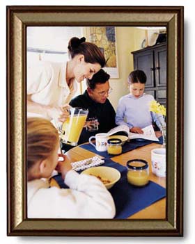 A framed picture of a family reading a SKITuations script for children's church at the breakfast table.