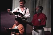 Three people read scripts in a Choral Reading.